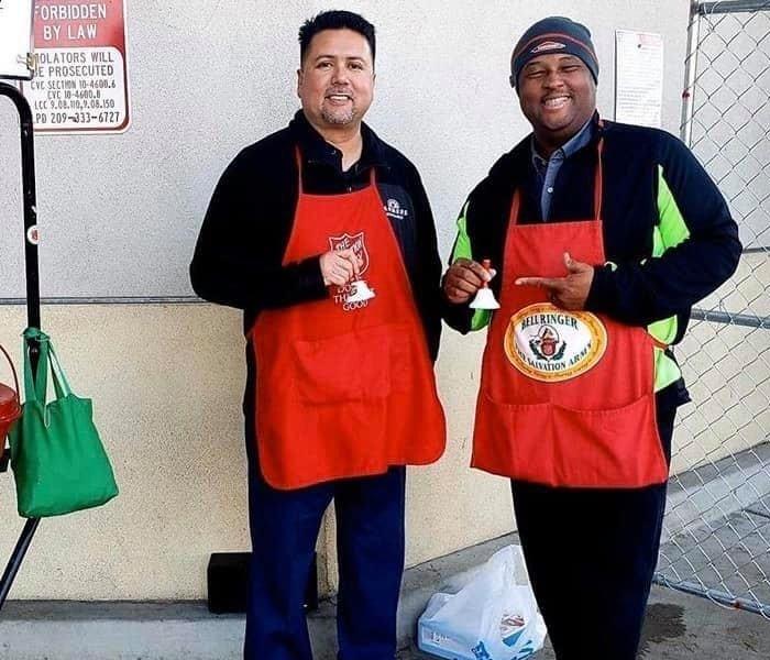 Two men giving community outreach