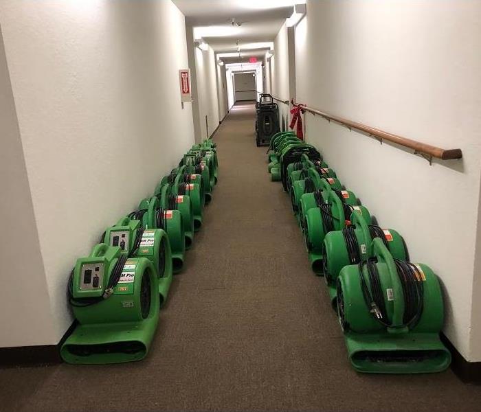 Equipment lined up in a hallway to help with water damage