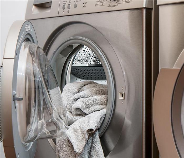 Dryer with a towel hanging outside of it