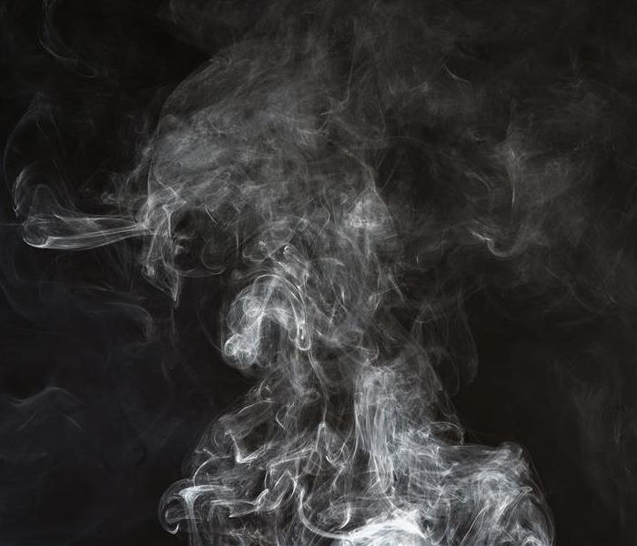 smoke rising and a black backdrop