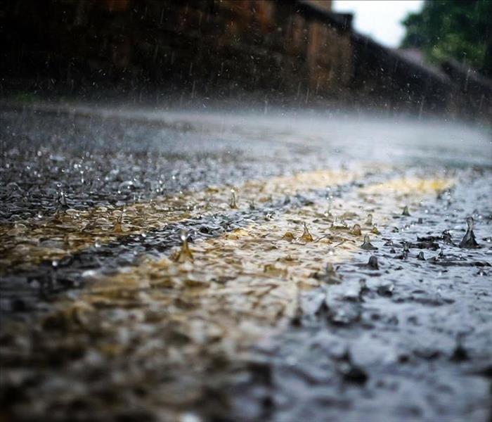 street with raindrops falling