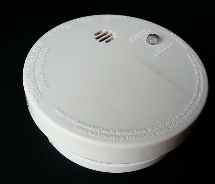 white smoke alarm with black background